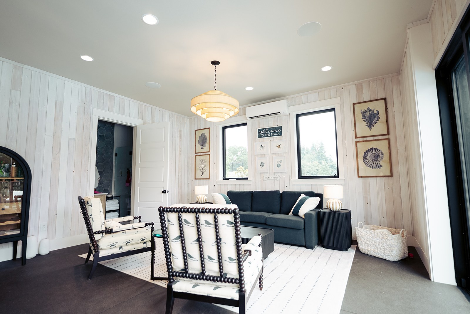 The pool house lounge in whitewashed wood and navy