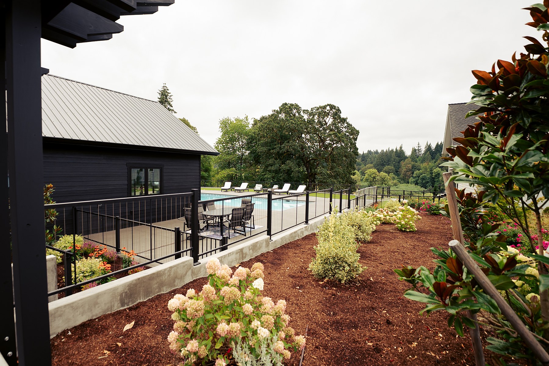 Gardens and the pool house, with the river valley beyond