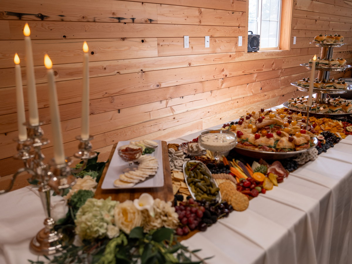 Silver candelabra and taper candles along the grazing table