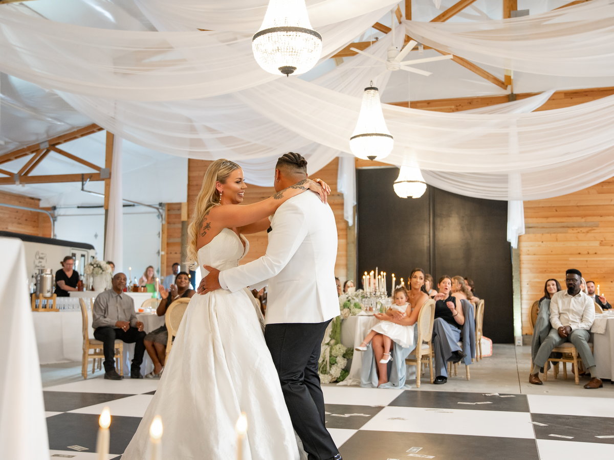 A first dance on the chequered floor as guests watch