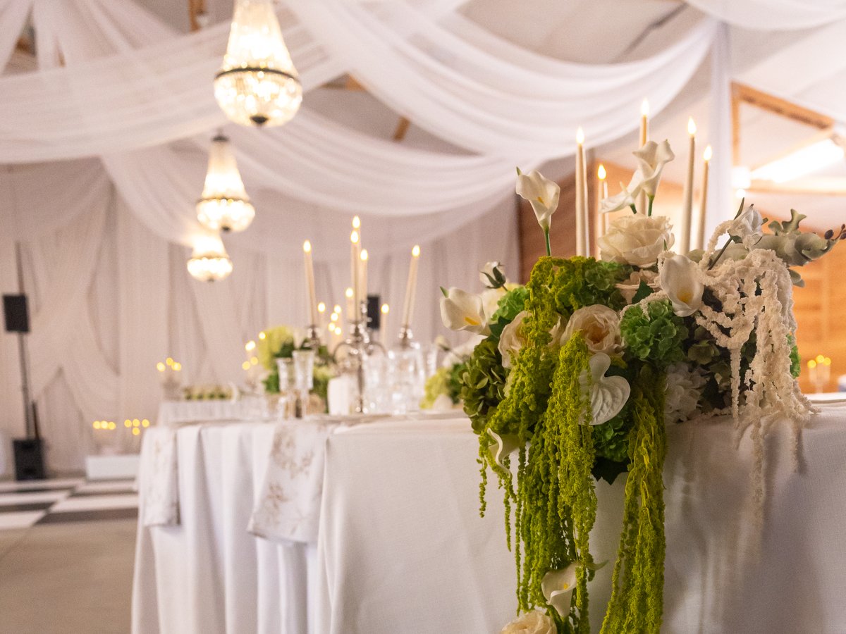 A floral garland trailing from the edge of the head table