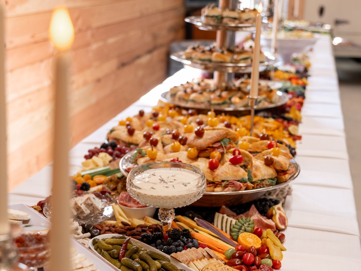 The grazing table laid end to end with tiered trays and candlelight